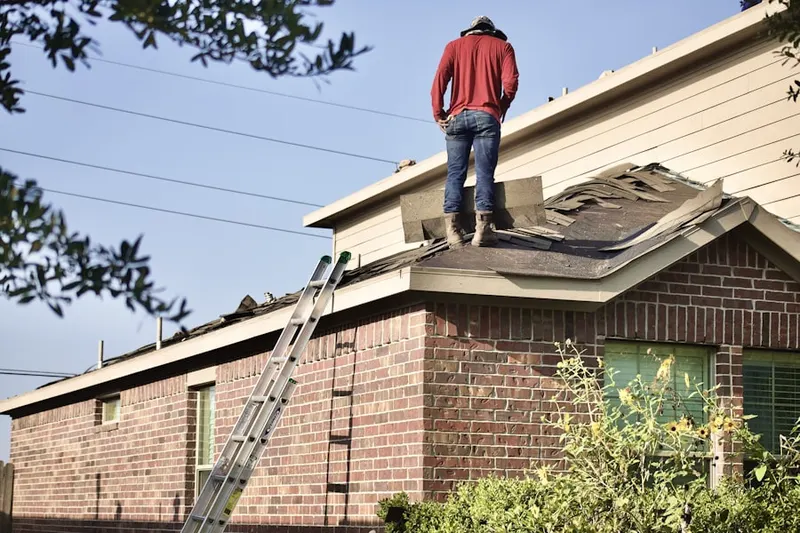 Professional roofer working on a residential roof in Fox Hollow Woods